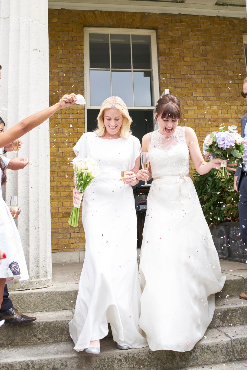 Same sex couple emerging from wedding