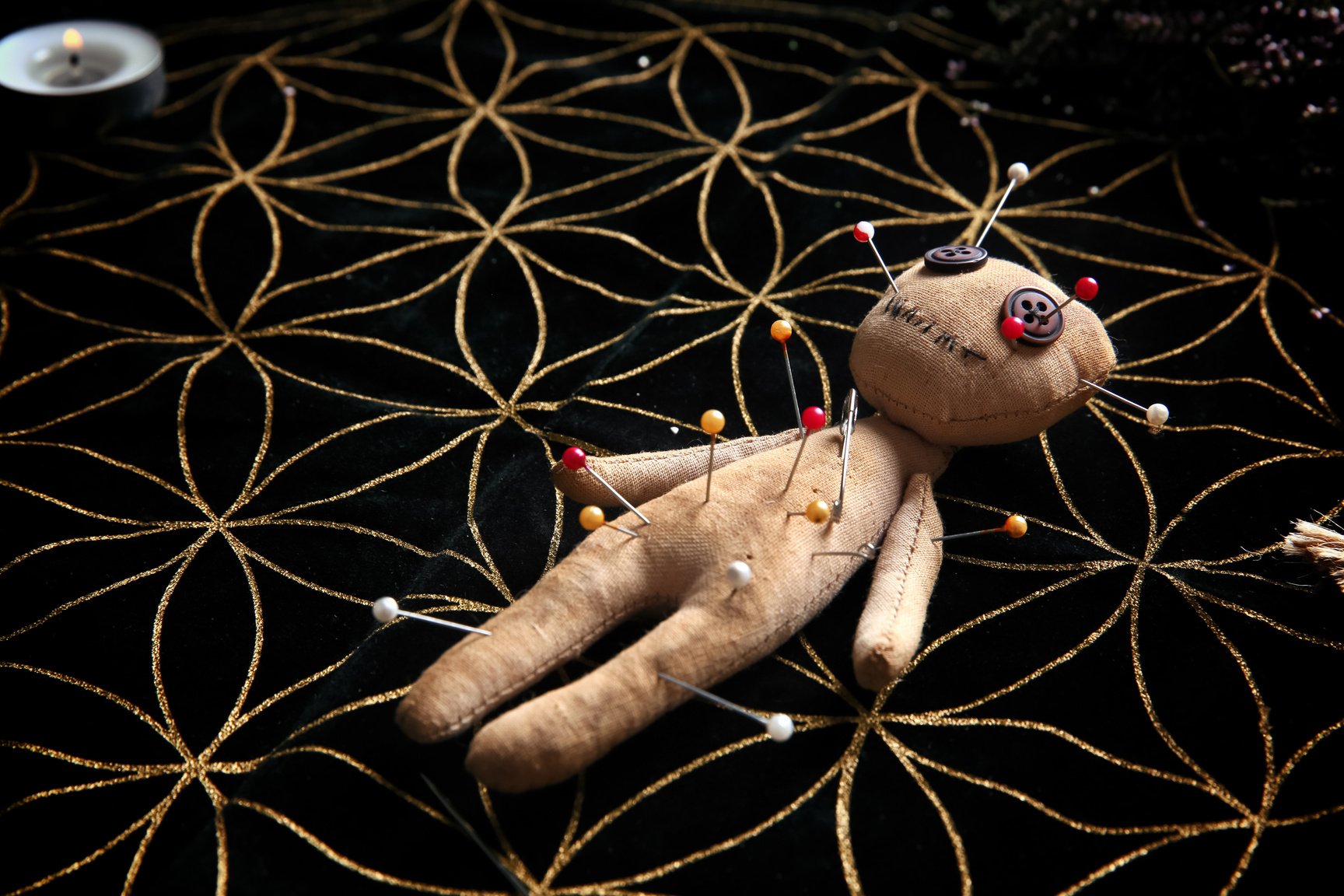 Voodoo Doll Pierced with Pins on Table. Curse Ceremony